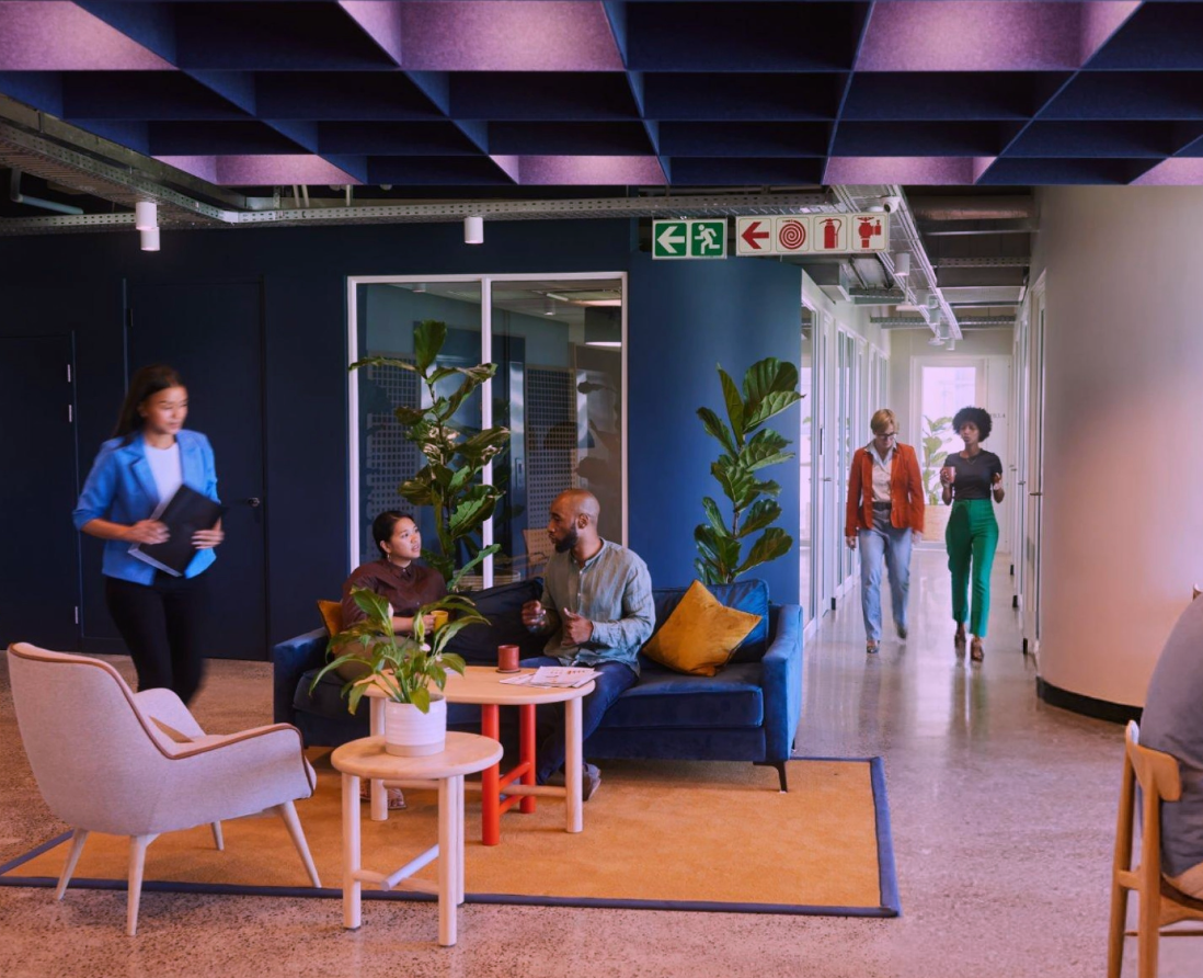 Individuals working quietly in a well-lit shared coworking area