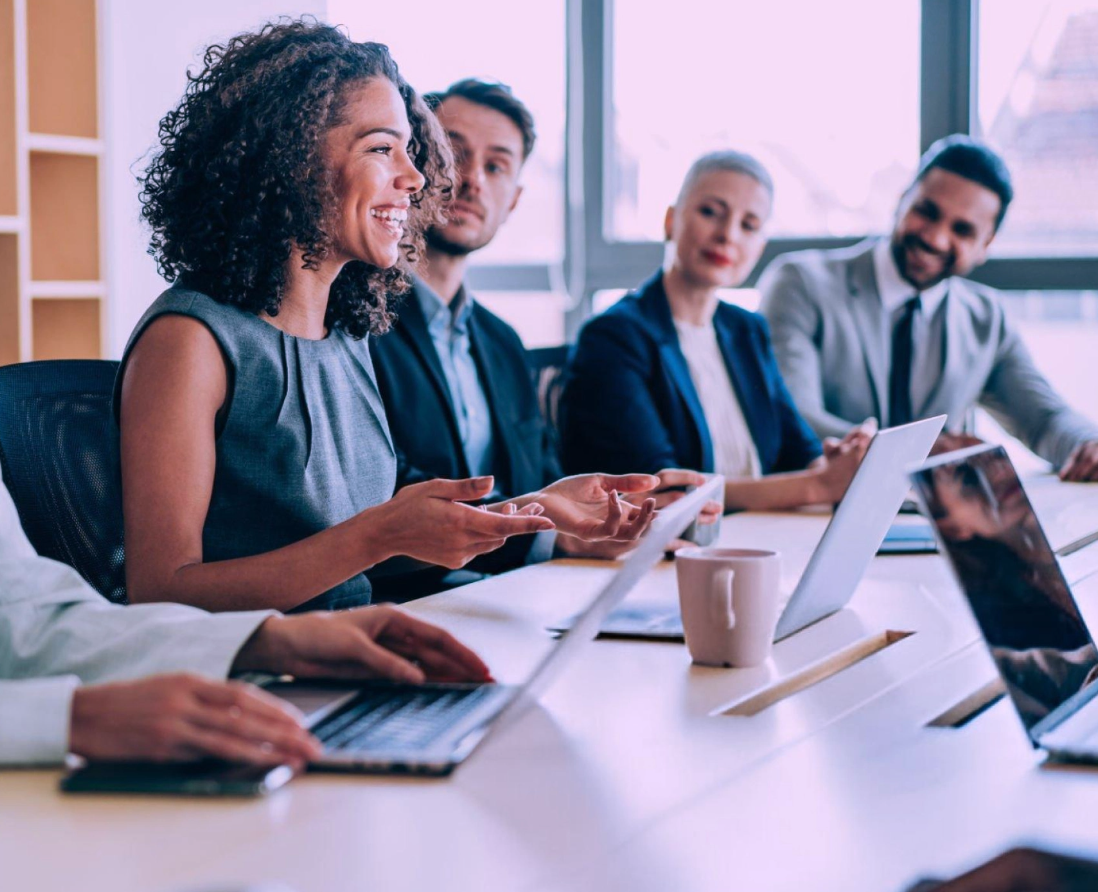IT manager collaborating with team members in a conference room